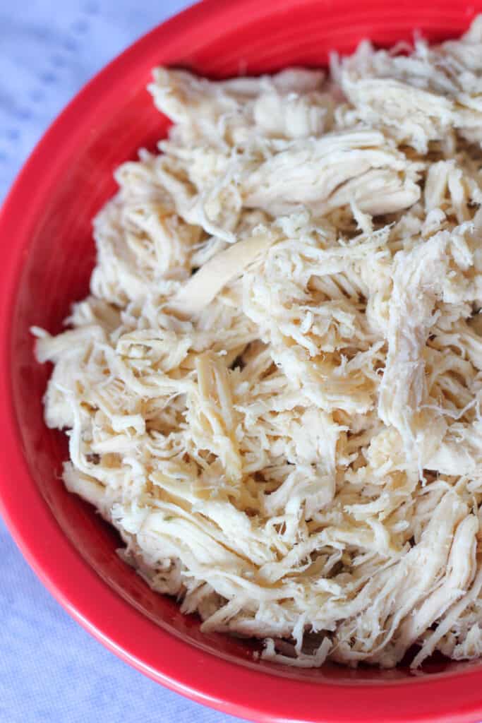 Slow Cooker Shredded Chicken in red bowl
