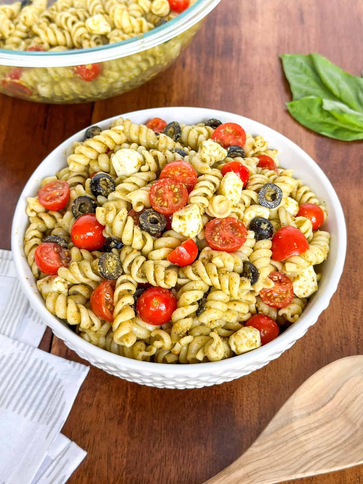 Two bowls of Easy Pesto Pasta Salad on a table.