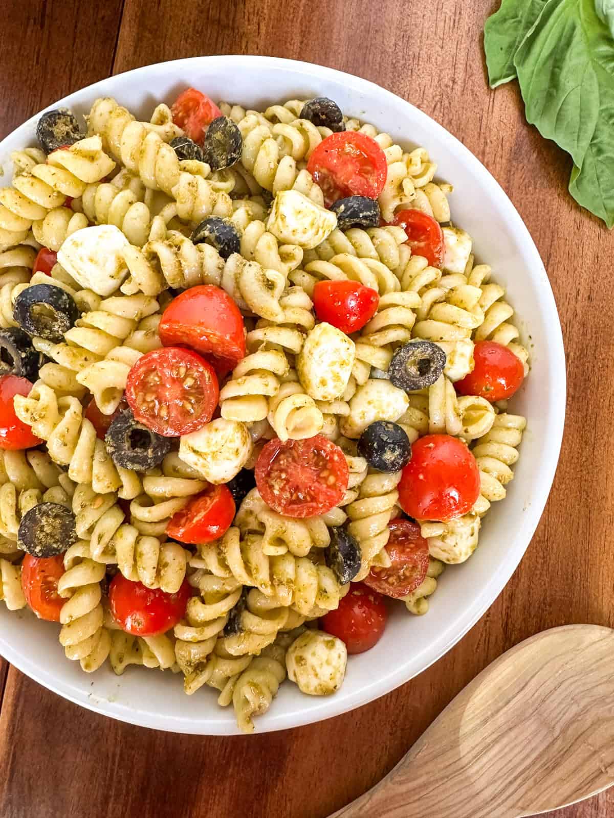 A bowl of Easy Pesto Pasta Salad on a table.