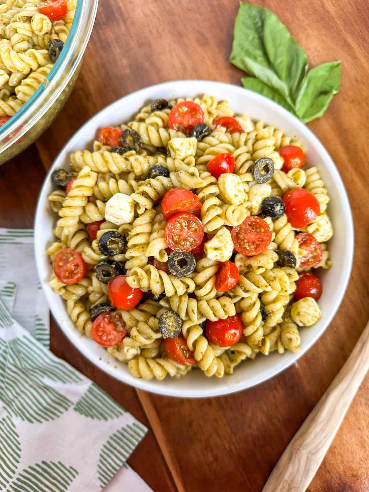 Two bowls of Easy Pesto Pasta Salad on a table.