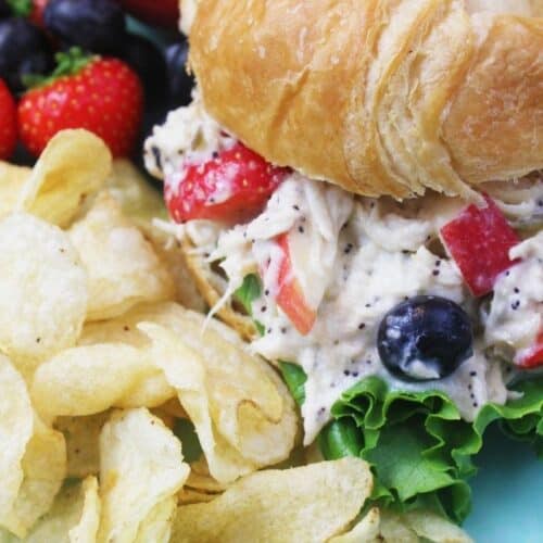 Poppyseed Chicken Salad Sandwich on a croissant with kettle chips and fruit