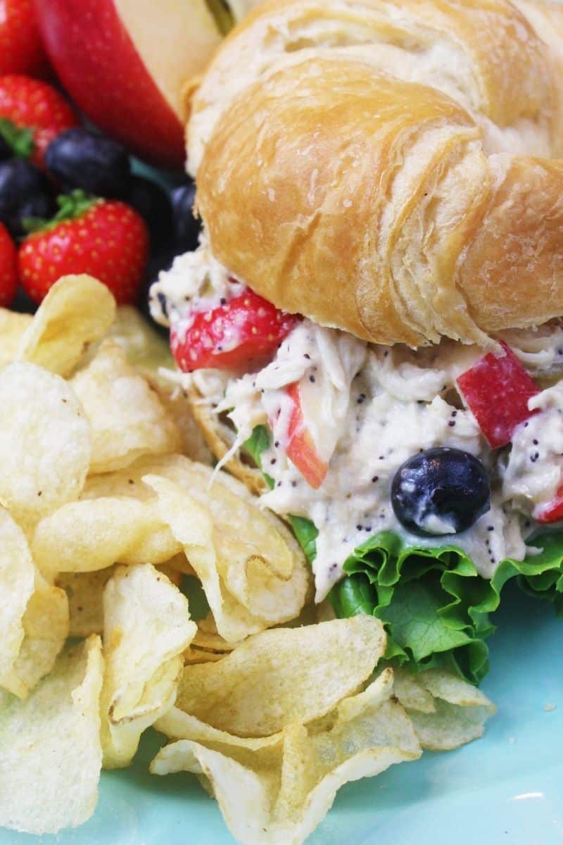 Poppyseed Chicken Salad Sandwich on a croissant with kettle chips and fruit