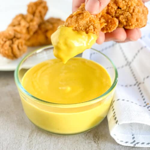 chicken strip dipped in Homemade Honey Mustard Sauce