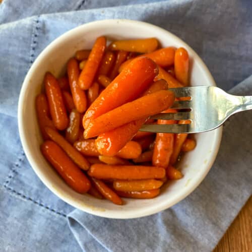 Brown Sugar Honey Glazed Carrots on a fork and in a bowl