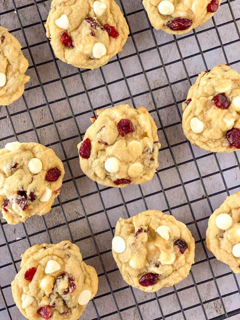 cooling rack of white chocolate chip cranberry sugar cookies