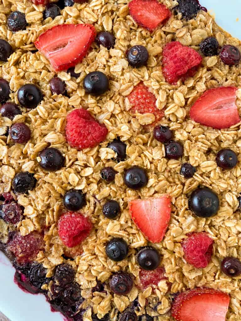 close up of finished easy mixed berry baked oatmeal in a pan