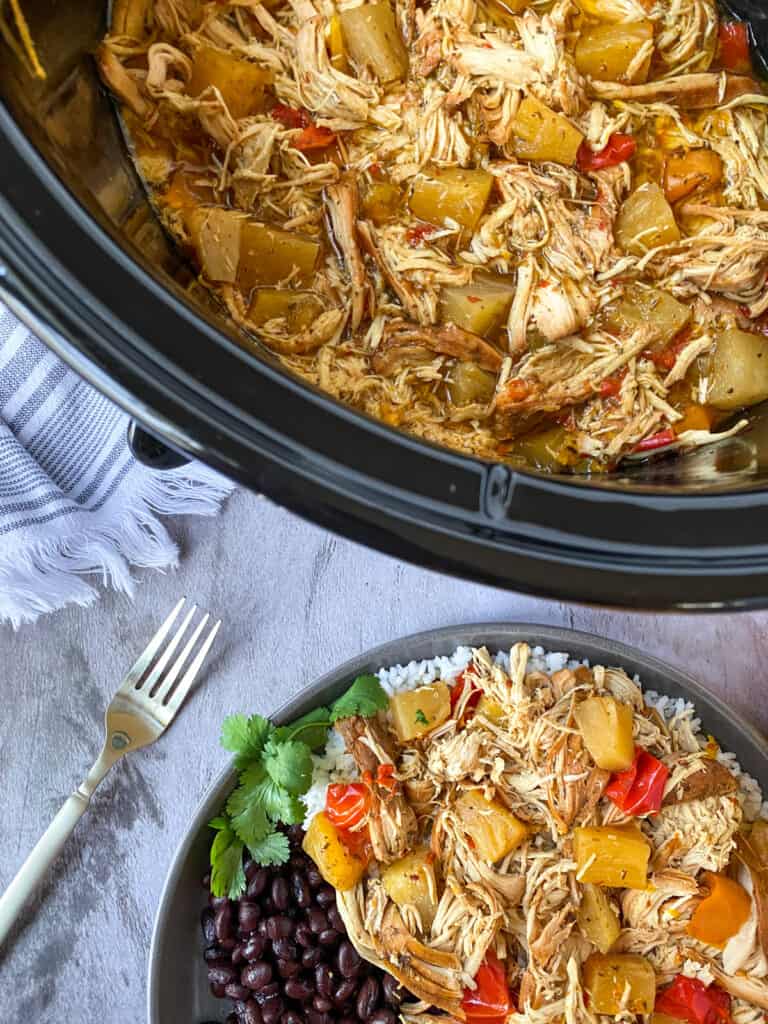 caribbean jerk chicken in a crock pot and on a plate with black beans