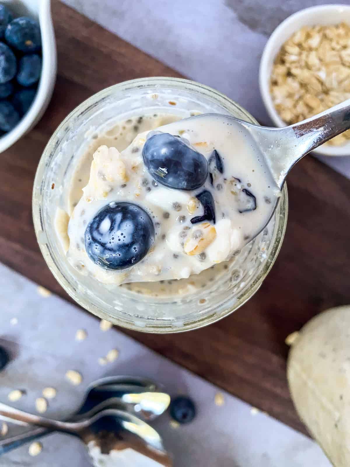 a scoop of oats from a jar on a spoon