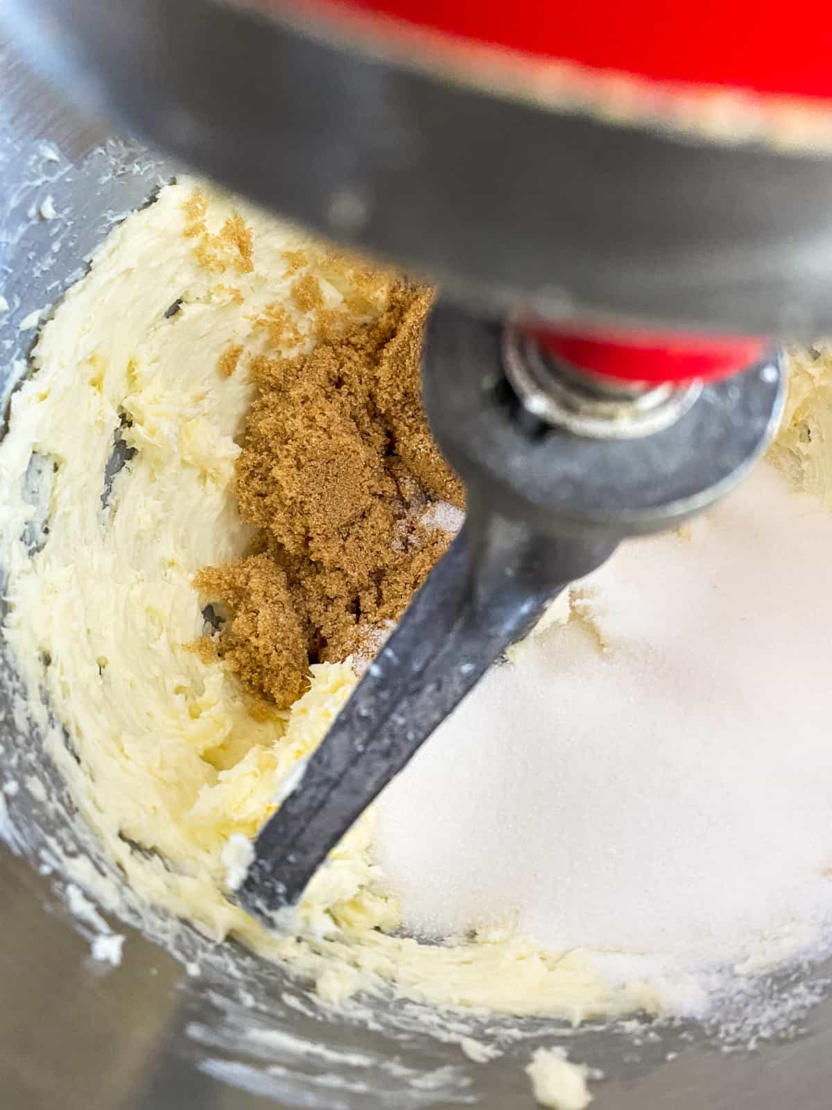 a kitchen aid stand mixer mixing together butter and sugars