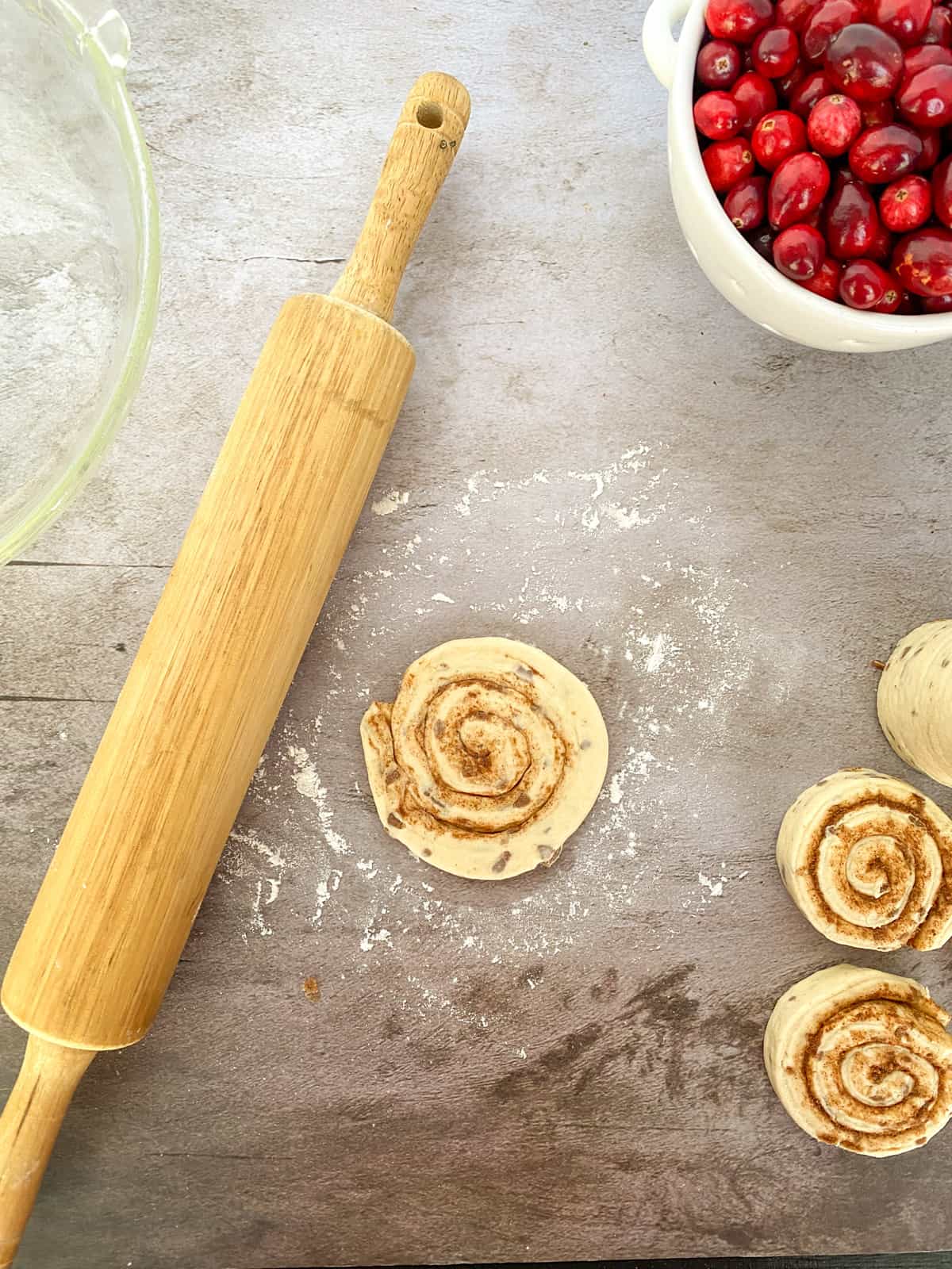 rolling out the cinnamon rolls on a table
