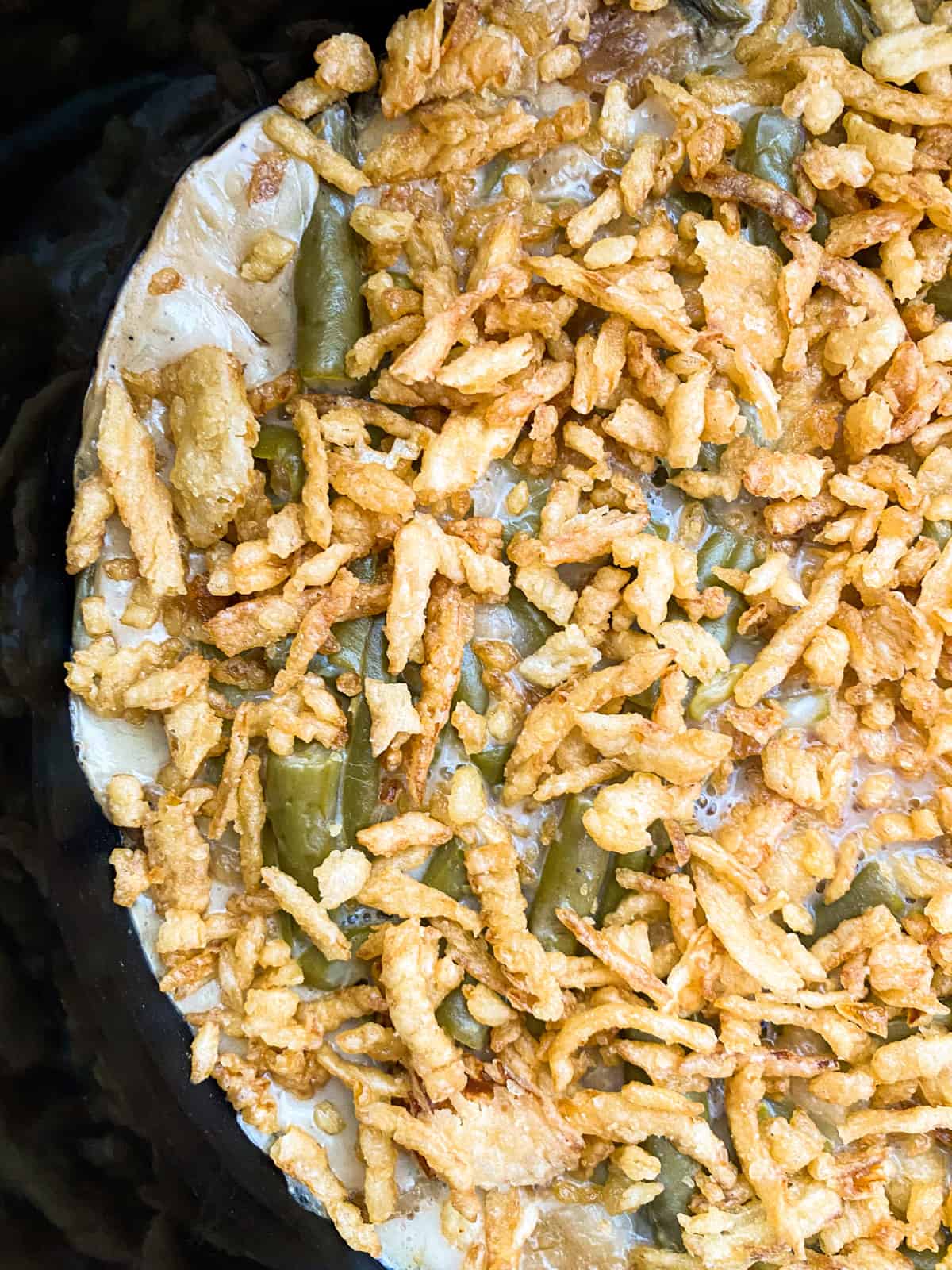 side view of the green bean casserole finished with crispy onion topping