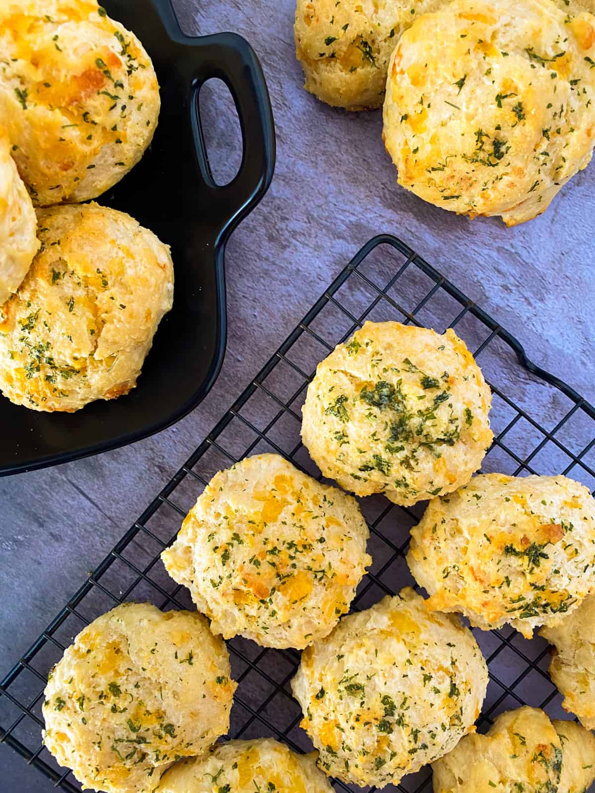 a baking sheet, a plate, and a few extra biscuits on a table
