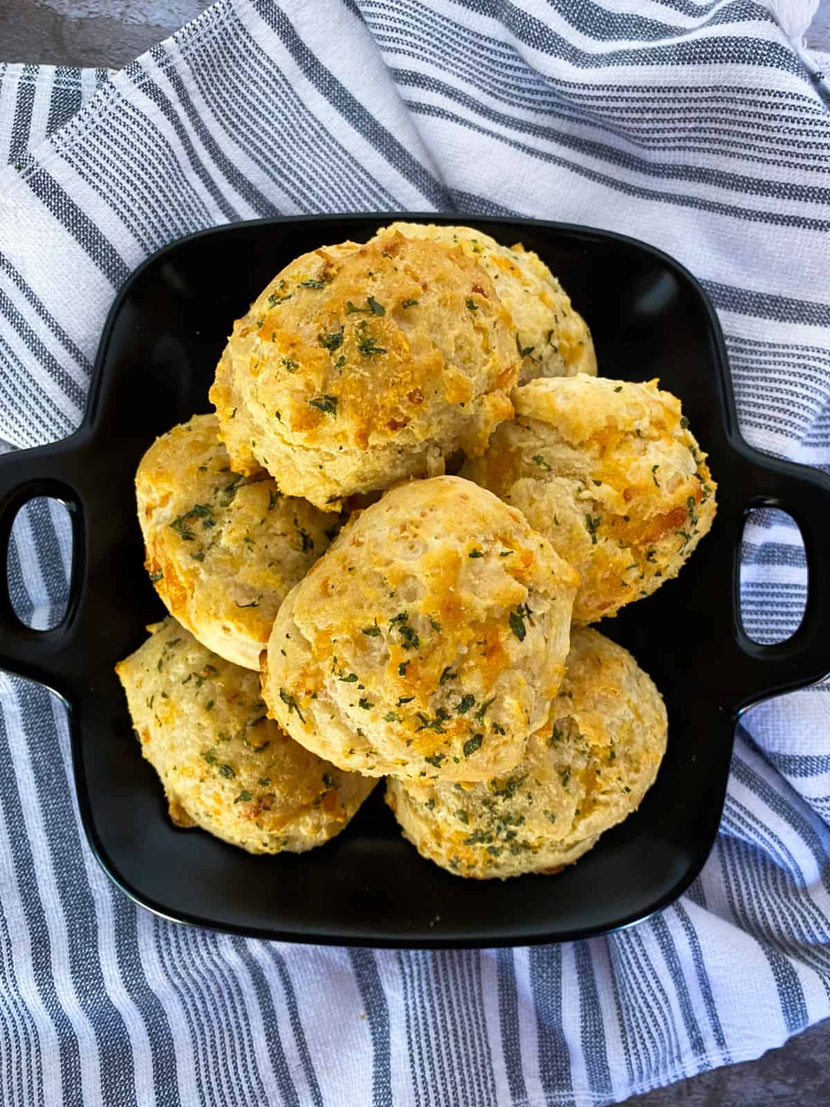 a plate full of cheddar bay biscuits