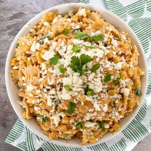 close up overhead view of a bowl filled with easy mexican street corn with queso fresco and cilantro on top