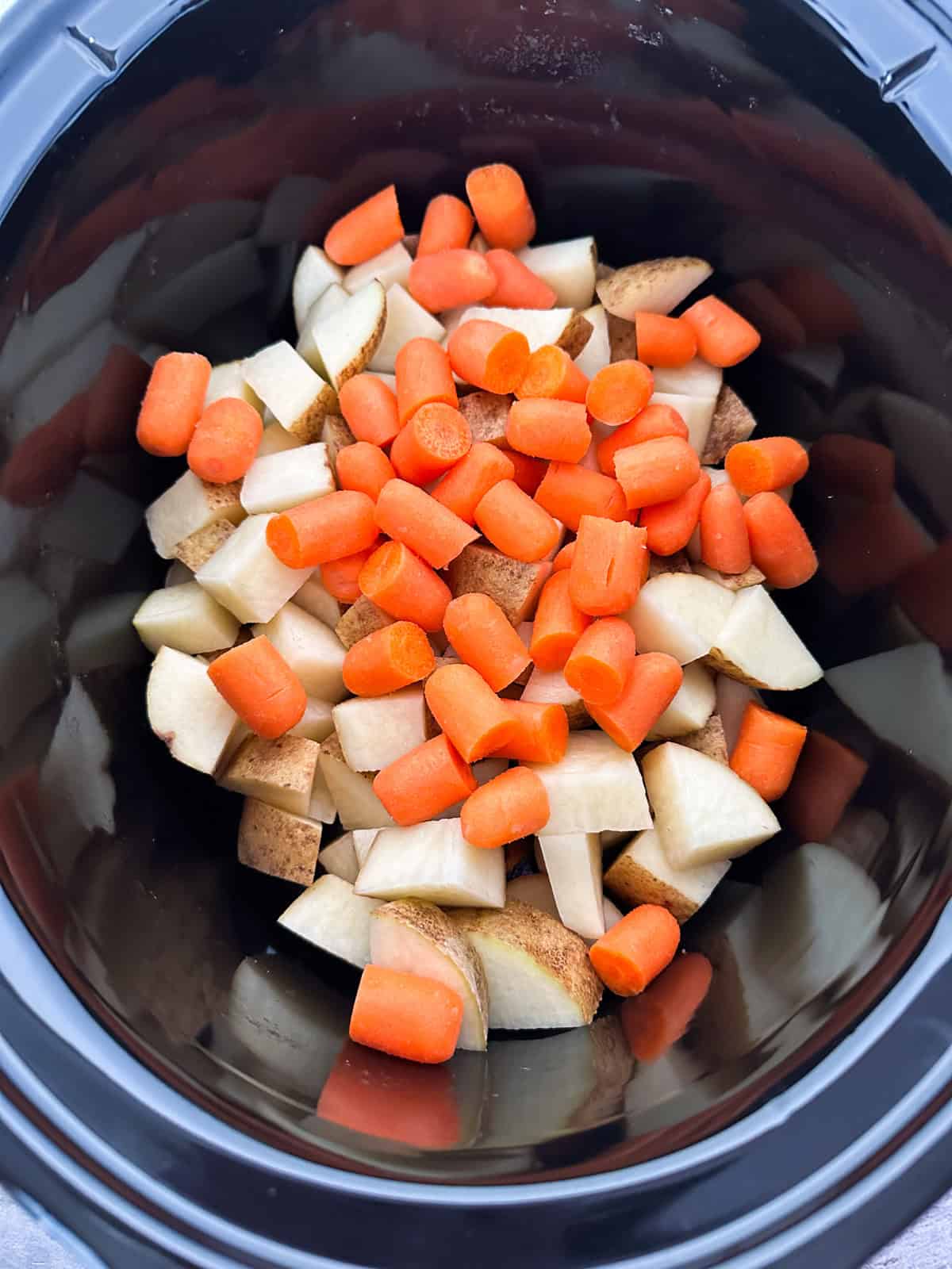 Potatoes and carrots in a crock pot.