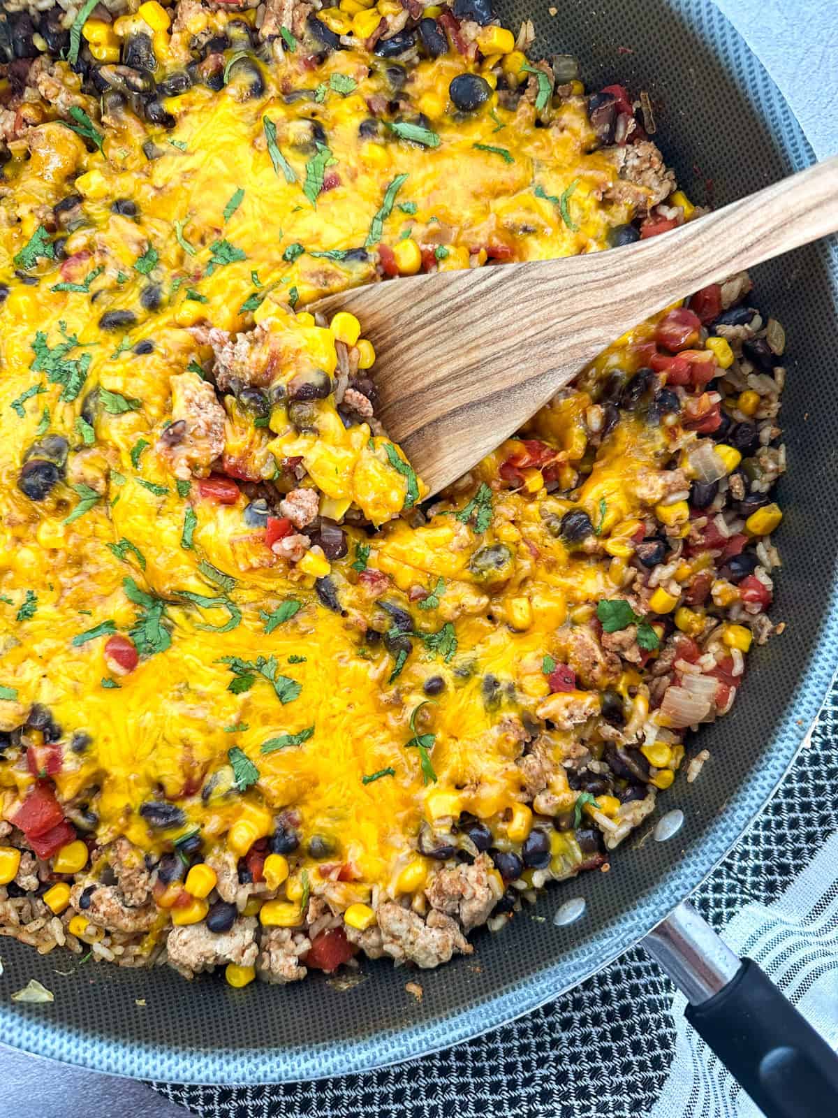 Ground Turkey Taco Skillet in a skillet with a spatula.