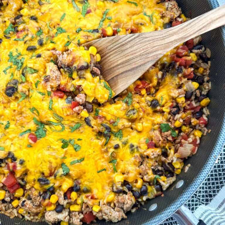 Ground Turkey Taco Skillet in a skillet with a spatula.