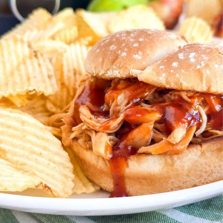 Apple BBQ Chicken Sandwich on a plate with chips.